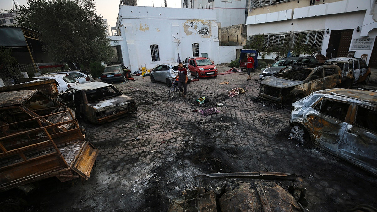 Palestinians check the place of the explosion at al-Ahli hospital, in Gaza City, Wednesday, Oct. 18, 2023