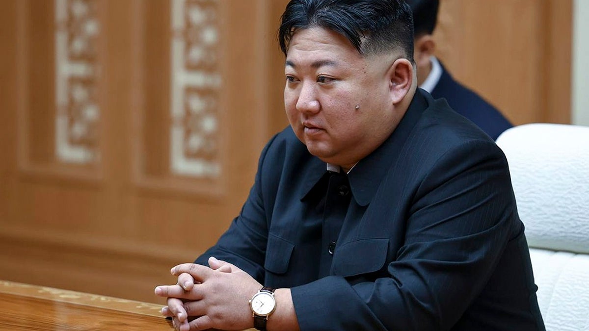 North Korean leader Kim Jong Un sits at a table