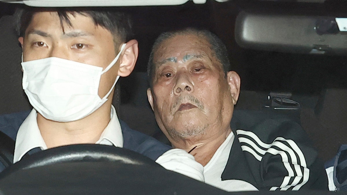 Hostage taker in Japan in back of a police car