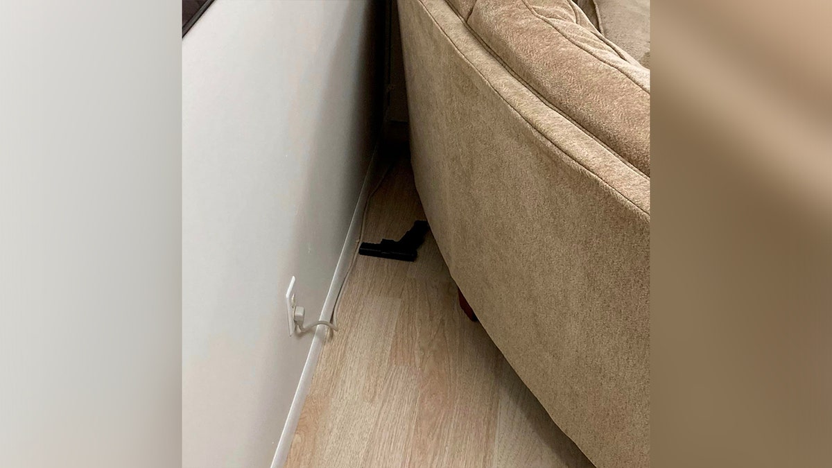 Gun hidden behind couch