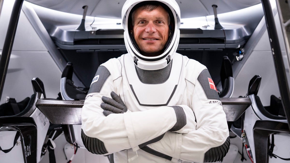 Andreas Mogensen posing in front of SpaceX Crew 7 Dragon Capsule