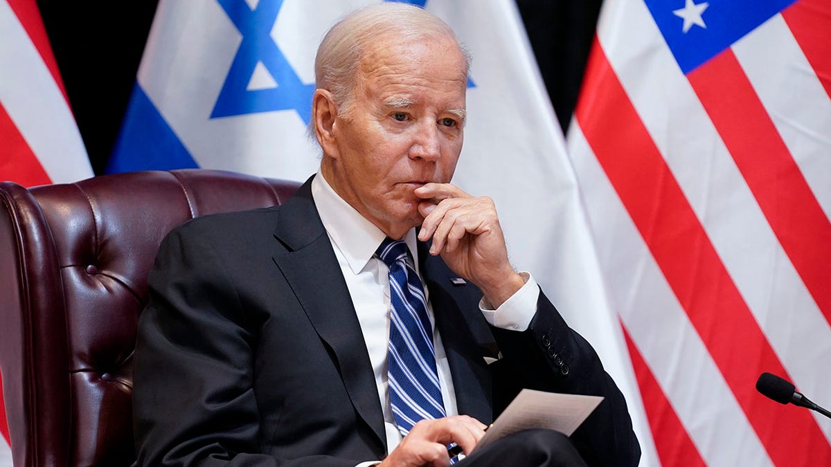 Biden listens during meeting in Israel