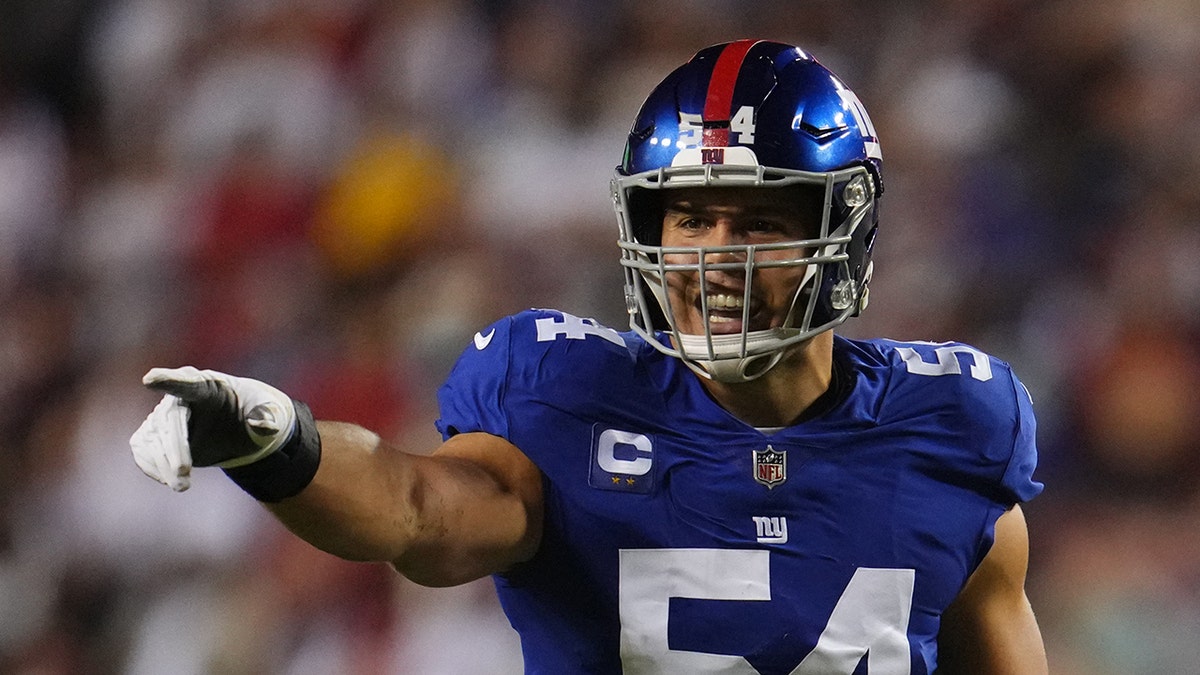 Blake Martinez points on field