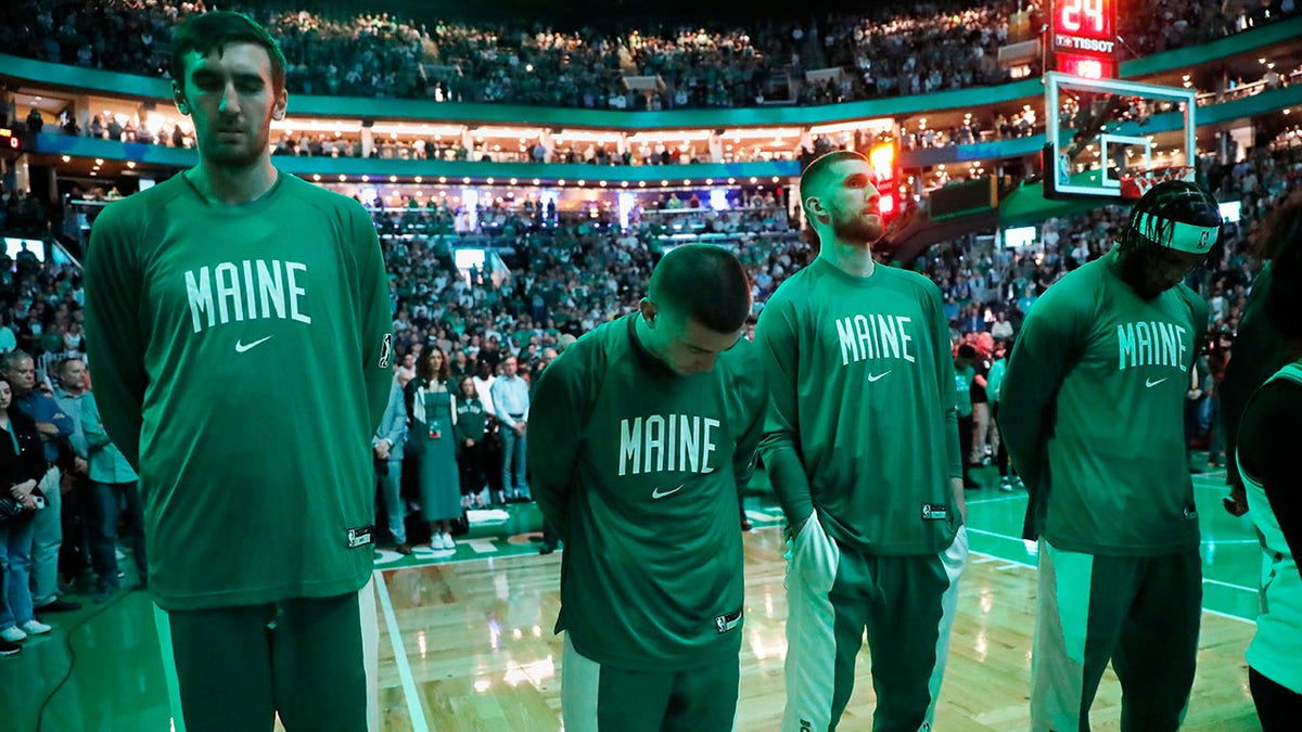 Boston Celtics stand for a moment of silence