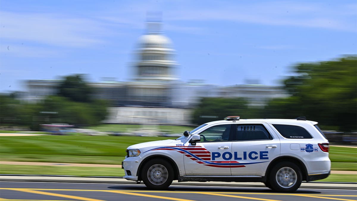 DC police SUV, US capitol blurry in background