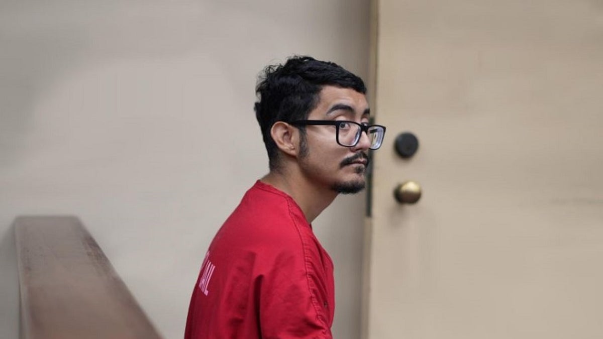 Giovanni Ceja sits hanscuffed in a Riverside County courtroom in an orange jumpsuit