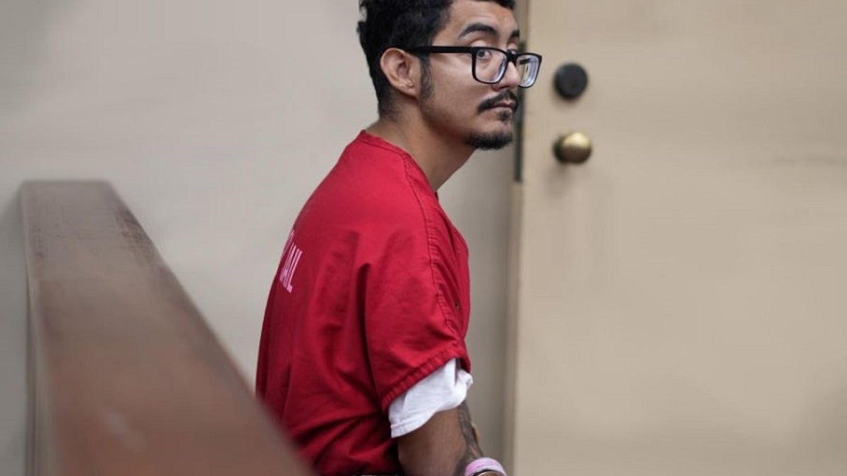 Giovanni Ceja sits hanscuffed in a Riverside County courtroom in an orange jumpsuit