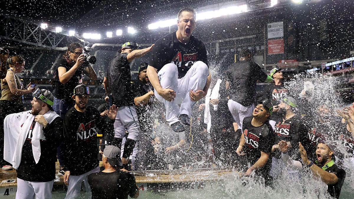 Arizona Diamondbacks players celebrate in the pool