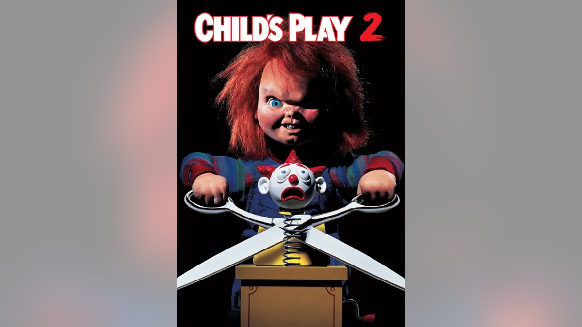 "Child's Play movie poster with doll and scissors