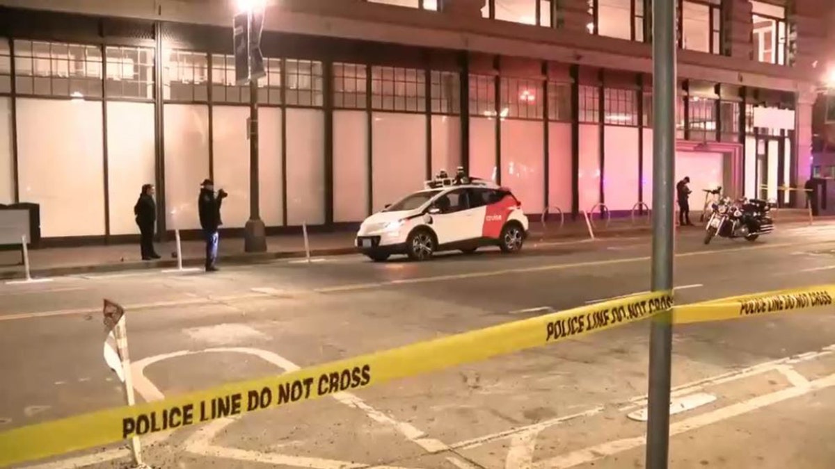 police investigating around parked Cruise vehicle