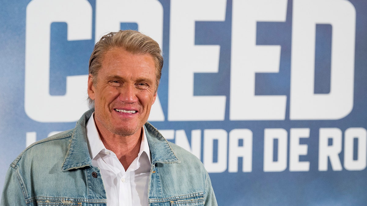 Dolph Lundgren posa davanti alla segnaletica Creed