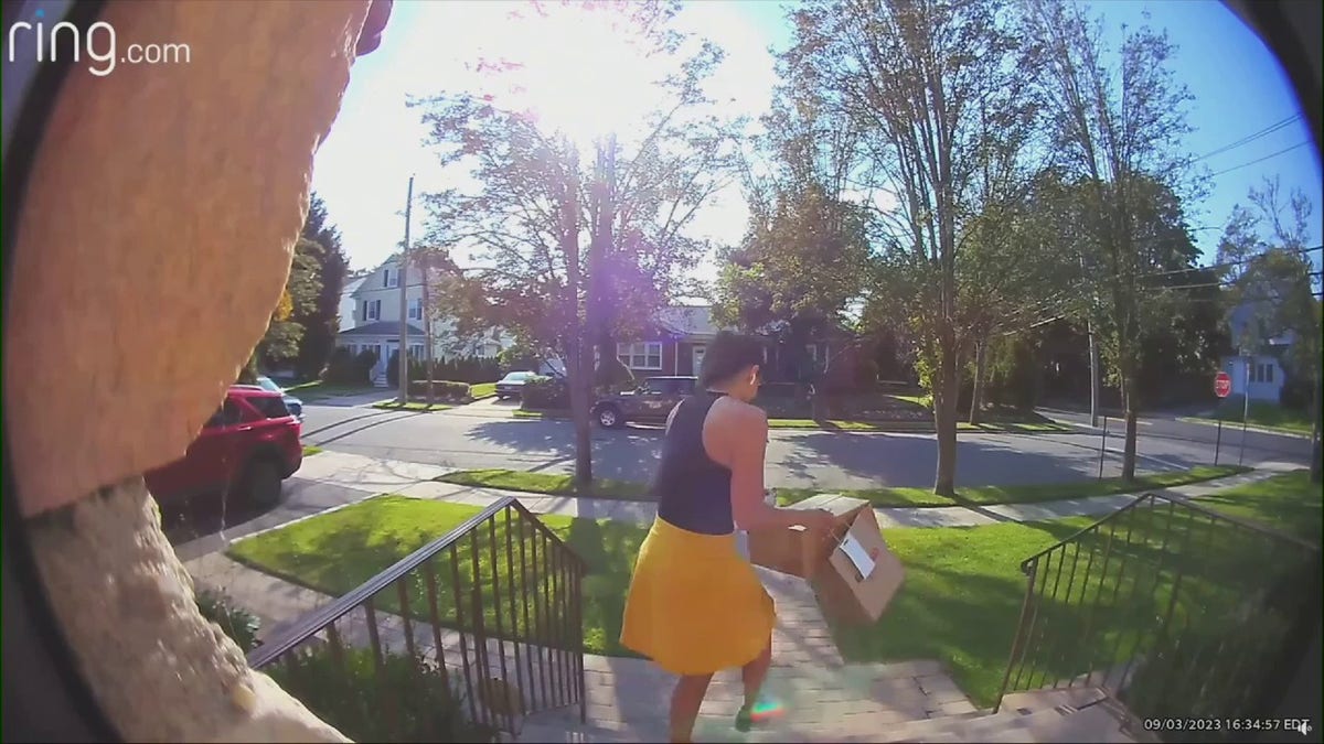 Woman stealing package from porch