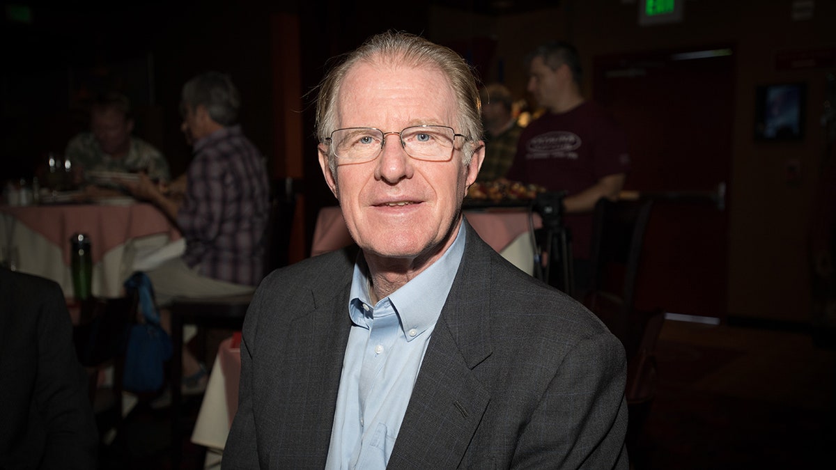 Ed Begley Jr sitting at a table