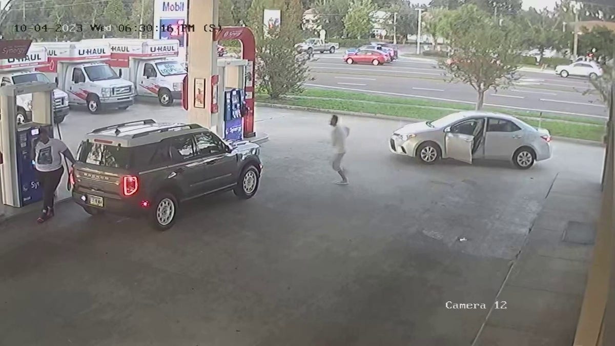 Man running toward car at gas station