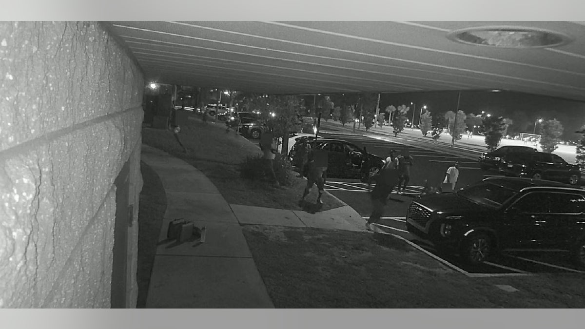 An image from a black and white surveillance video showing a shootinf of young football players in a Florida park.