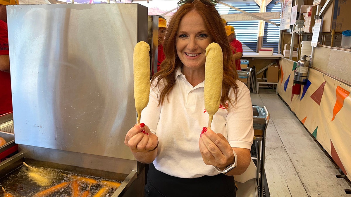 Amber Fletcher holds corny dogs in Texas