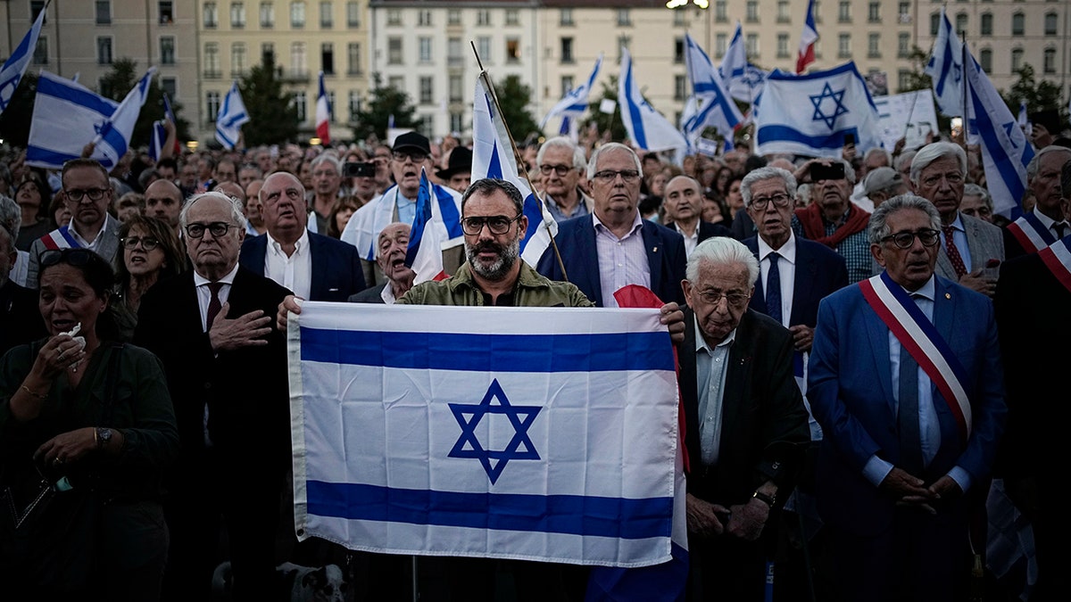 Citizens holding Israeli flag