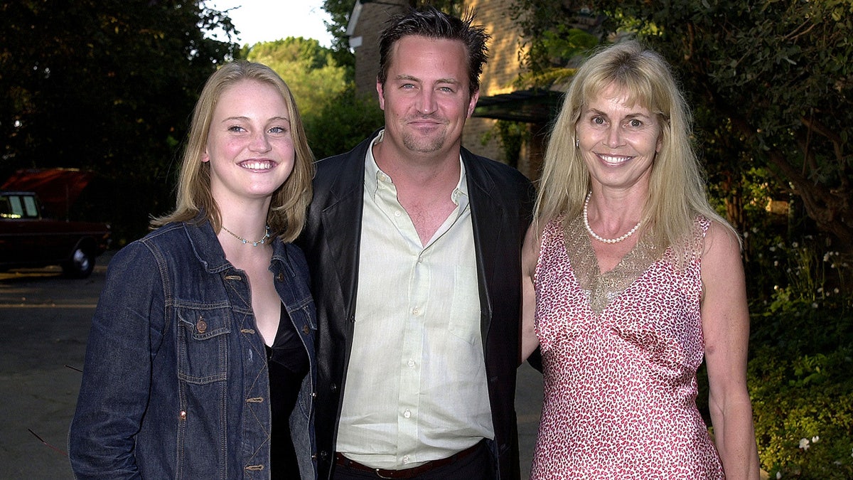A photo of Matthew Perry with his mother and sister
