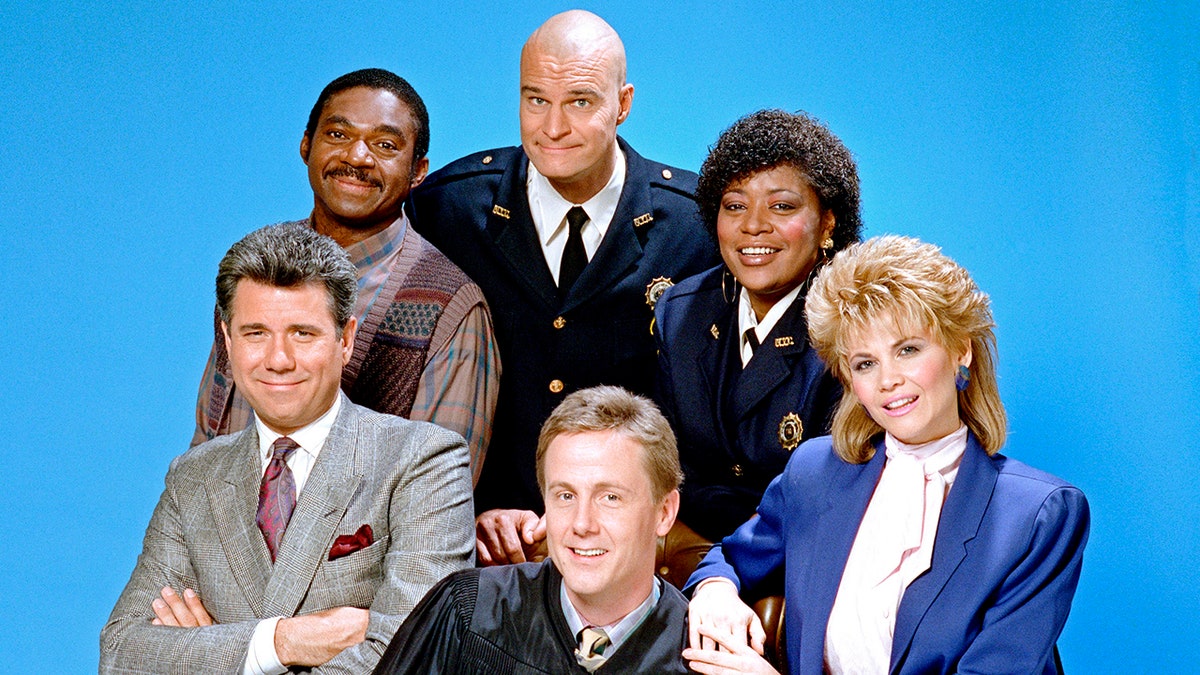 The cast of "Night Court" including Richard Moll, Marsha Warfield, Markie Post, Harry Anderson, John Larroquette, Charles Robinson in a photo from season 4