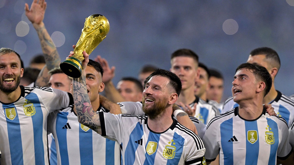 Messi with the World Cup trophy