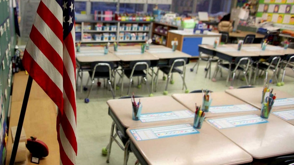 empty first grade classroom with american flag hanging
