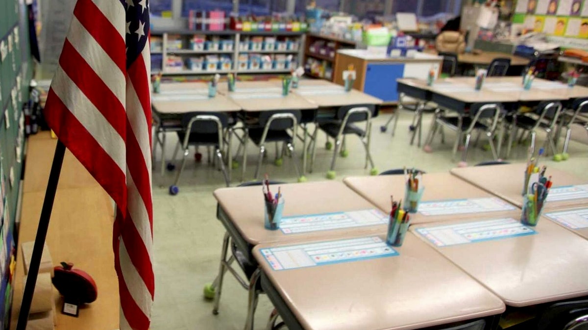 empty first grade classroom with american flag hanging
