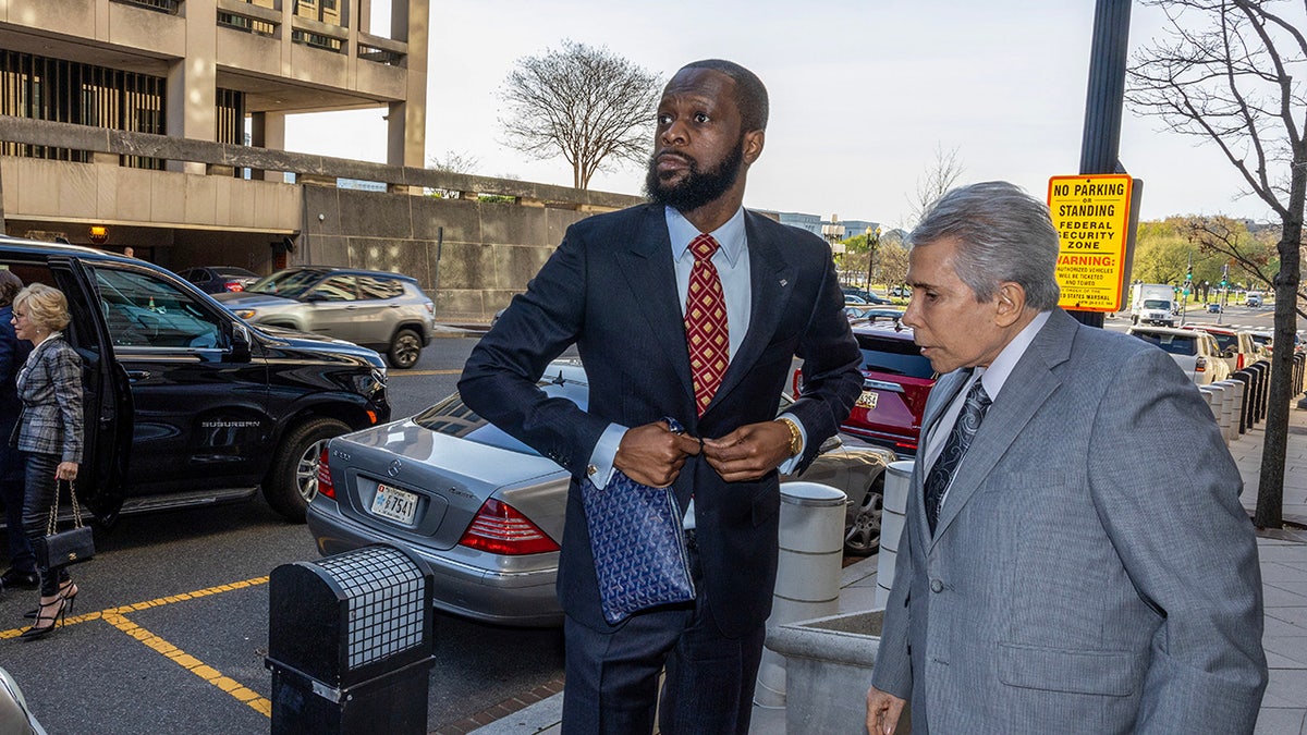 Pras Michel fixes suit outside courthouse with attorney by his side