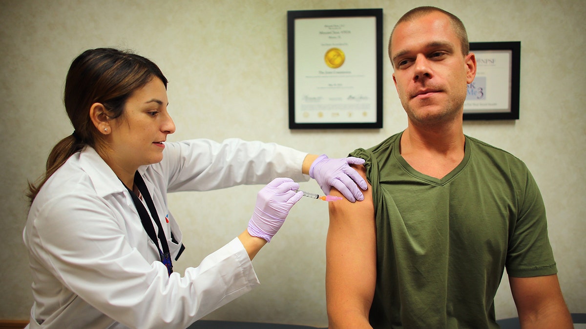 doctor gives flu vaccination