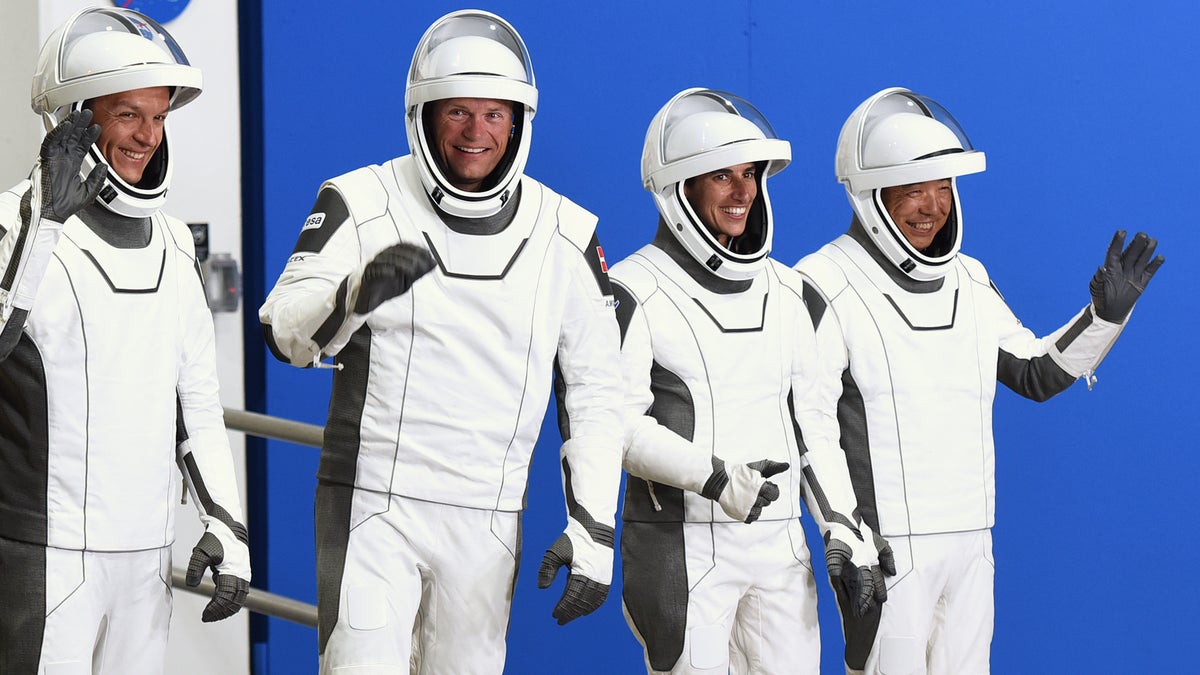 Crew-7 members wave to the cameras while wearing their space suits before launch