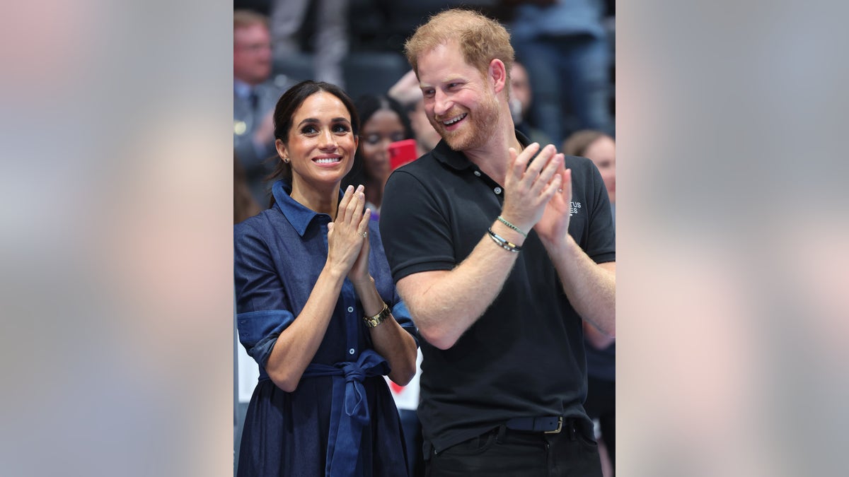 Meghan Markle and Prince Harry applauding together
