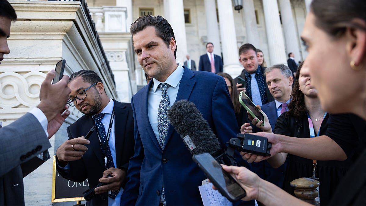 Matt Gaetz leaves while surrounded by reporters in Washington