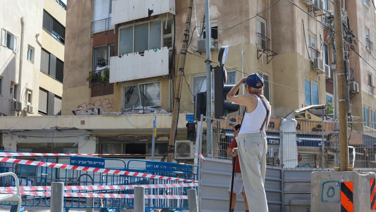 Elderly man looking at Tel Aviv damage