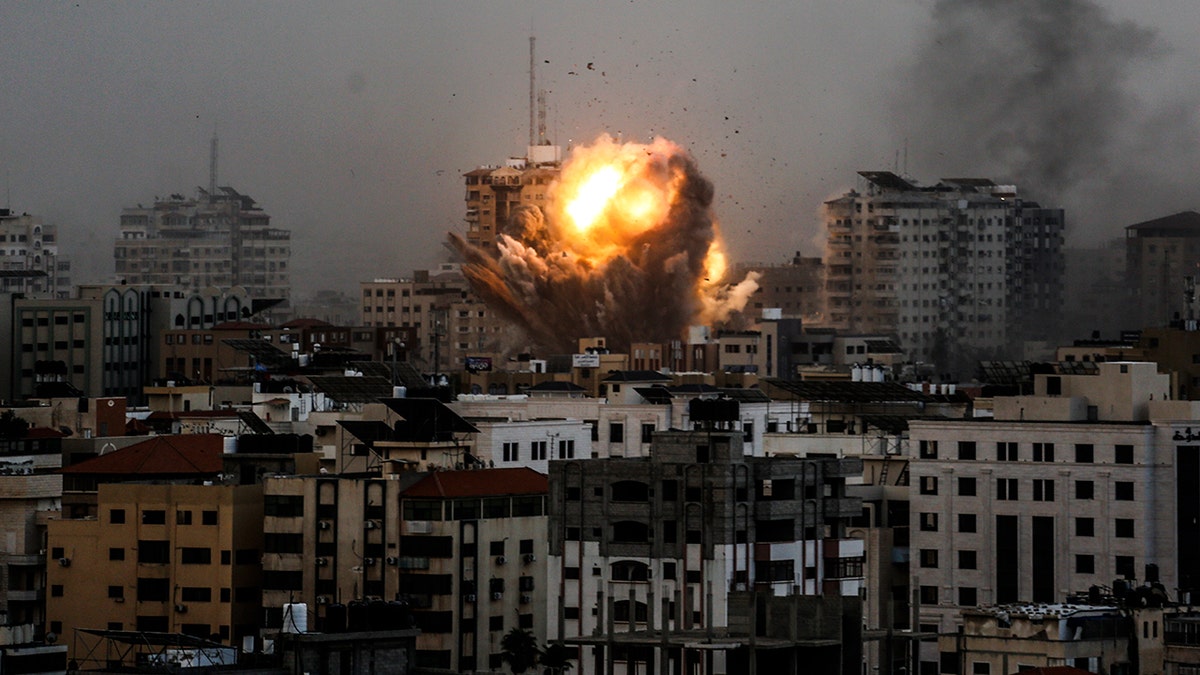 A smoke rises and ball of fire over a buildings in Gaza City