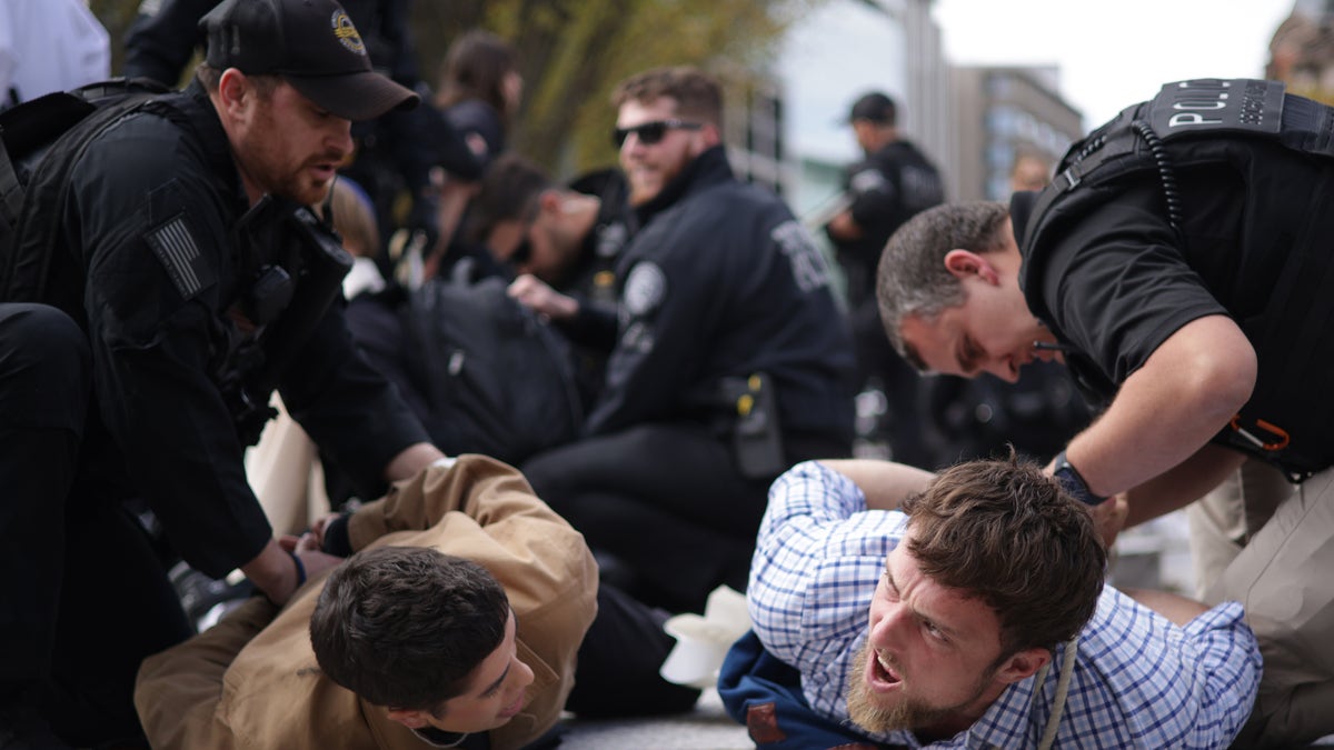 Protestors are detained by law enforcement personnel during a demonstration to support Gaza outside the White House