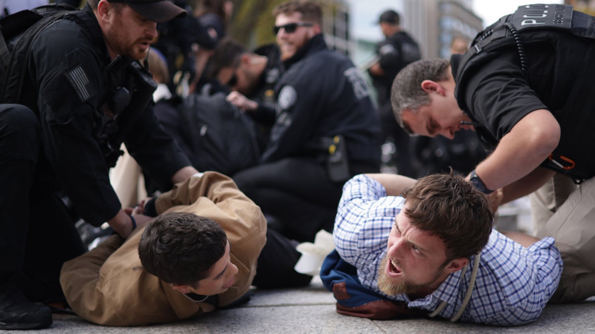 Protestors are detained by law enforcement personnel during a demonstration to support Gaza outside the White House