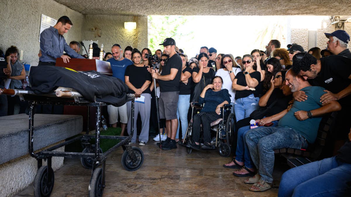 A family mourns at the funeral of a victim killed by Hamas terrorists at the Nova music festival