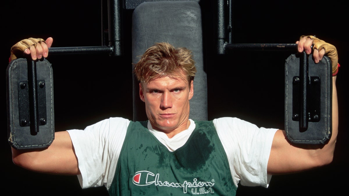 Dolph Lundgren posing on weight equipment