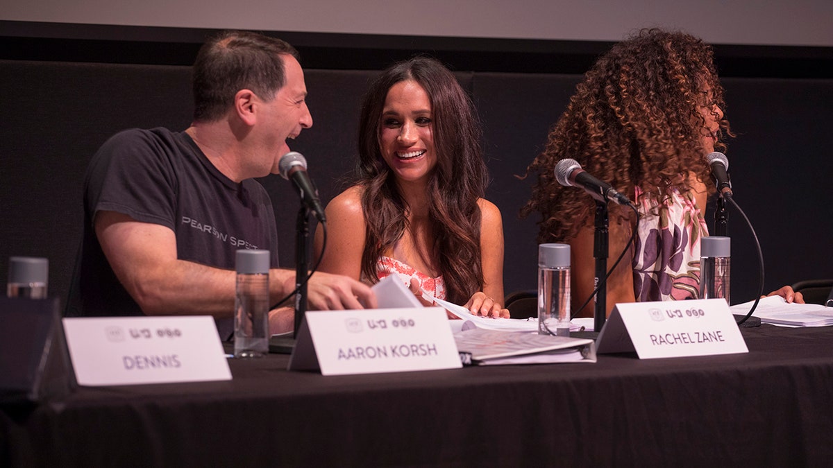 Aaron Korsh sitting with Meghan Makrle at a table