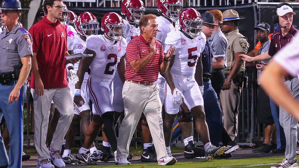 Nick Saban takes the field with his team
