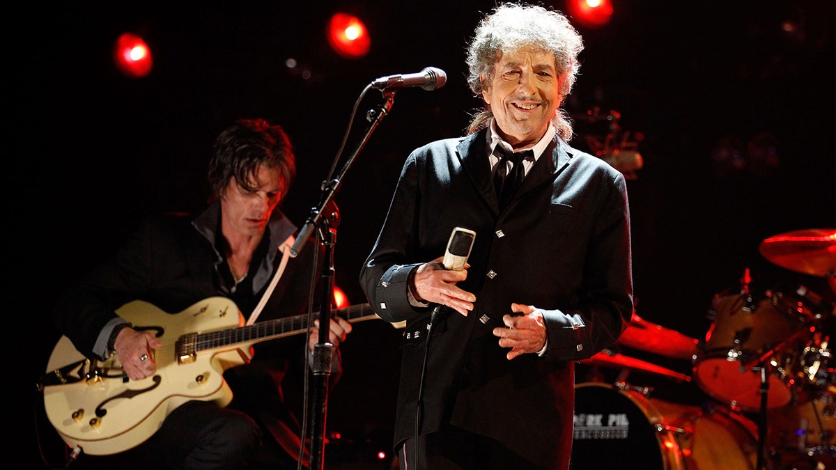 Bob Dylan smiling on stage