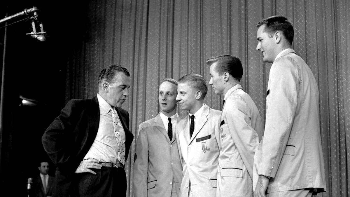 Ed Sullivan talking to The Four Preps on stage