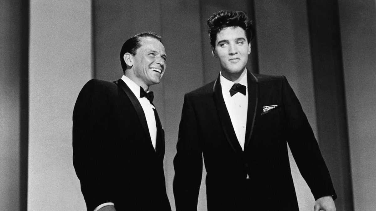 Frank Sinatra and Elvis Presley smiling and wearing matching suits and bow ties