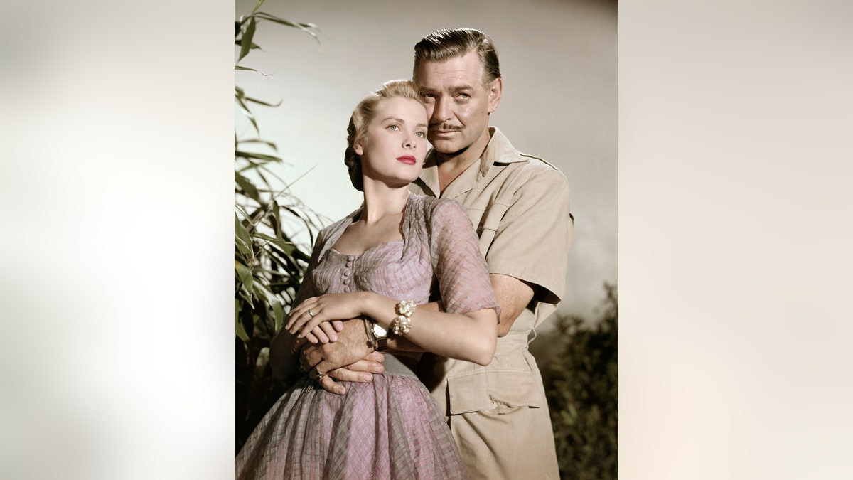 Clark Gable embracing Grace Kelly in costume for the film "Mogambo"