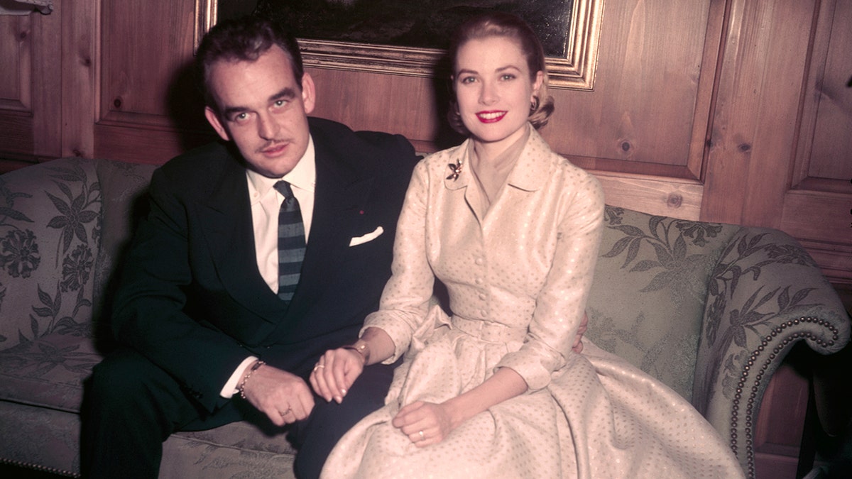 Prince Rainier in a suit and Grace Kelly in an ivory gown