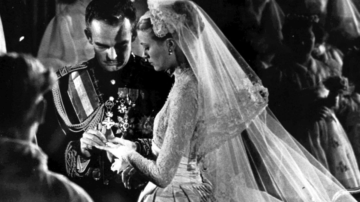 Prince Rainier of Monaco placing a ring on the finger of his bride Grace Kelly
