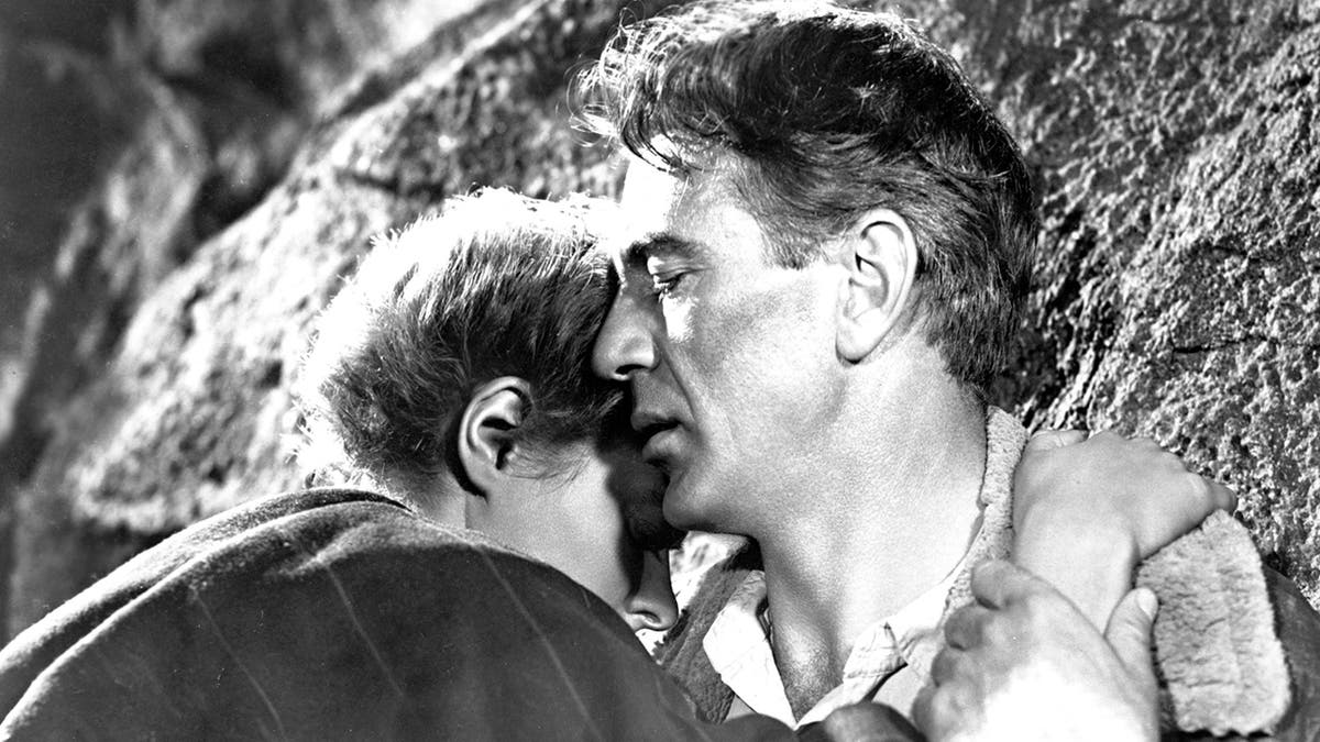 A close-up of Gary Cooper embracing Ingrid Bergman