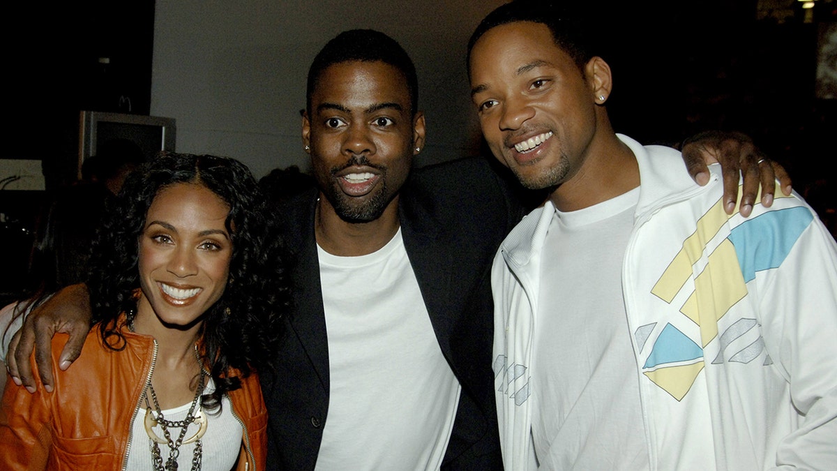 Jada Pinkett Smith Chris Rock and Will Smith smiling in casual wear