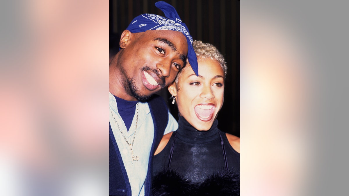 A close-up of Tupac Shakur smiling and Jada Pinkett Smith in mid sentence