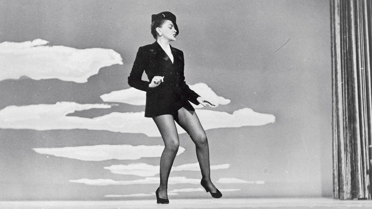 Judy Garland dancing in a short suit and fedora