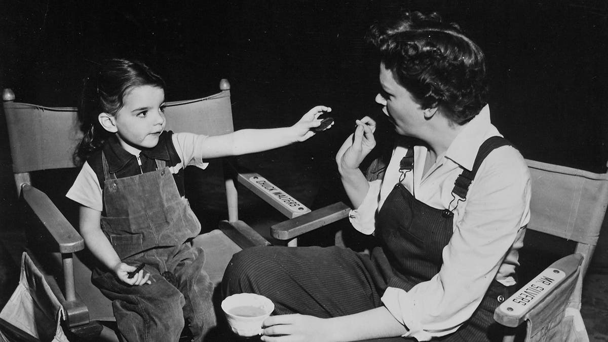 Judy Garland looking at her daughter Liza who is pointing something at her